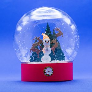 Snow Globe with Snowman, trees and playful reindeer made from paper.