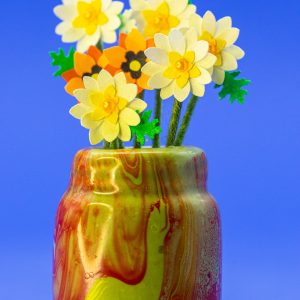 1-inch-tall ceramic multi-color tan, red, and yellow vase with punch flowers.