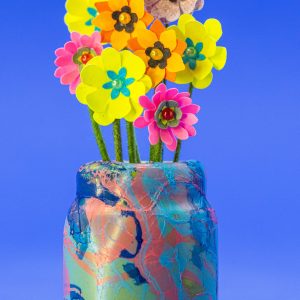 1-inch-tall ceramic multi-color blues and pinks vase with punch flowers.