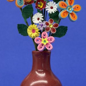 Red vase with colorful quilled paper flowers.