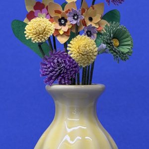 Yellow ceramic vase with purple, green and yellow flowers