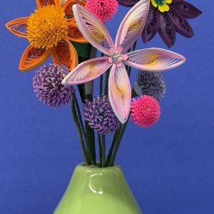 Green ceramic vase with colorful quilled paper flowers