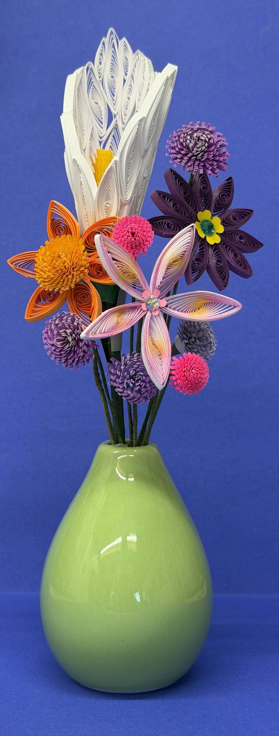 Green ceramic vase with colorful quilled paper flowers