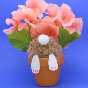This cute bunny is digging in the terra cotta flowerpot with and all you can see is his behind. The overall size is 7x7".