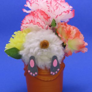 This cute bunny is digging in the terra cotta flowerpot with and all you can see is his behind. The overall size is 7x5".