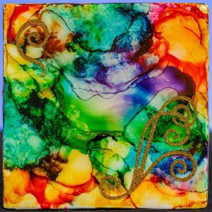This one-of-a-kind design is created with Alcohol Ink that creates interesting images. This 5x5 trivet has felt feet and gold swirl stickers.