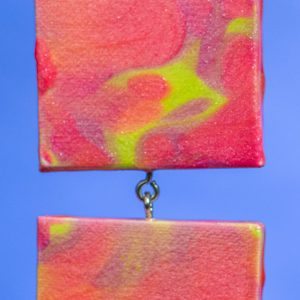 These 2.75x2.75 canvases were created with a "paint pour" method. I've joined 2 together and added a string to hang them from for a total length of 8.5".
