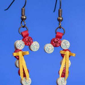These earrings made with 1/8″ white paper and red paper. They have a glitter finish on the front. They have a tiny bow made of gold paper. These earrings are 1 3/8″ long by 3/8″ wide. The drop length is 2″.